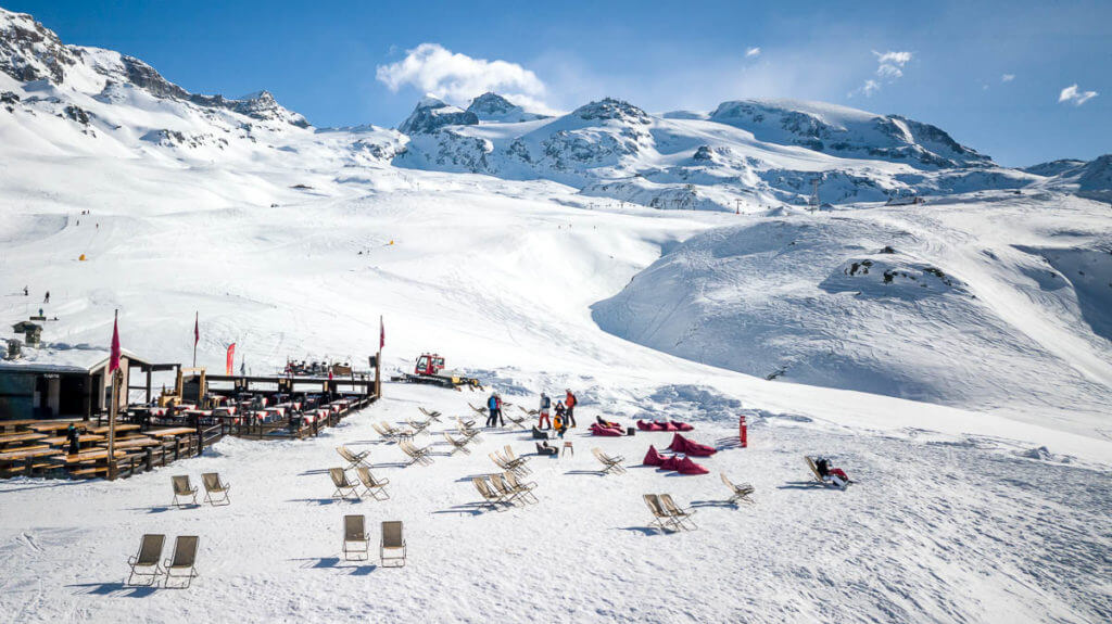 Panorama of Cervinia Cervinia ski resort, Italy. Beautiful landscape in the Alps. Sun loungers on the background of mountains