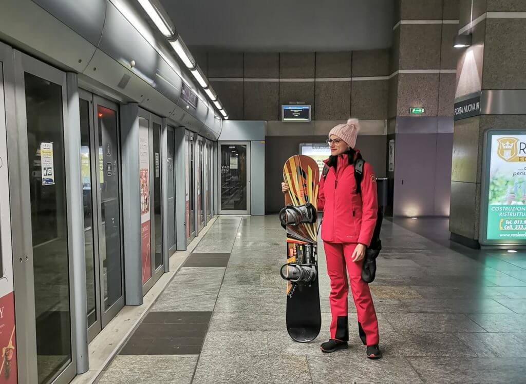 Woman waiting for a metro in Turin, she is going skiing in Bardonecchia by train.