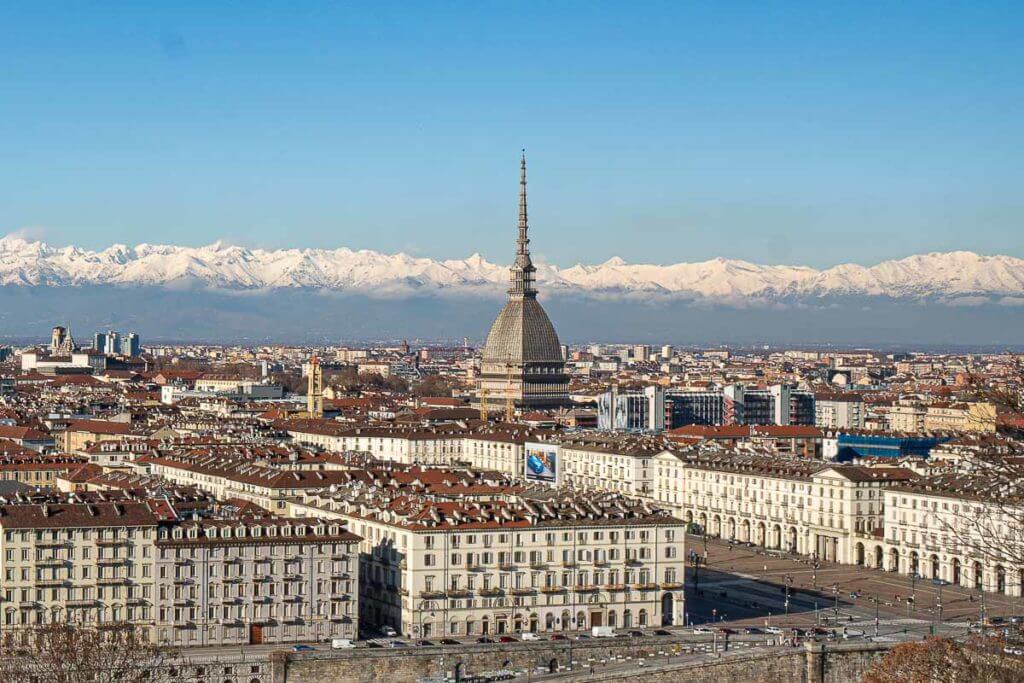 Photo of Turin skyline with the Italian Alps in the background, they are covered in snow.